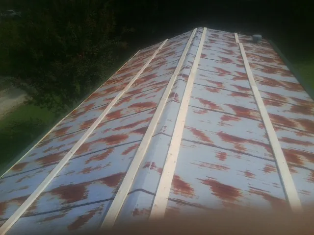 Rusted metal roof panels with new wood purlins before replacement — Storm Damage Roof Repair in Mechanic Falls by Roofing Brothers